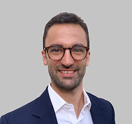Pablo Garcia Lopez, Director, Connected Intelligence, wearing a dark blue suit jacket over a white collared shirt, posed against a plain light gray background.