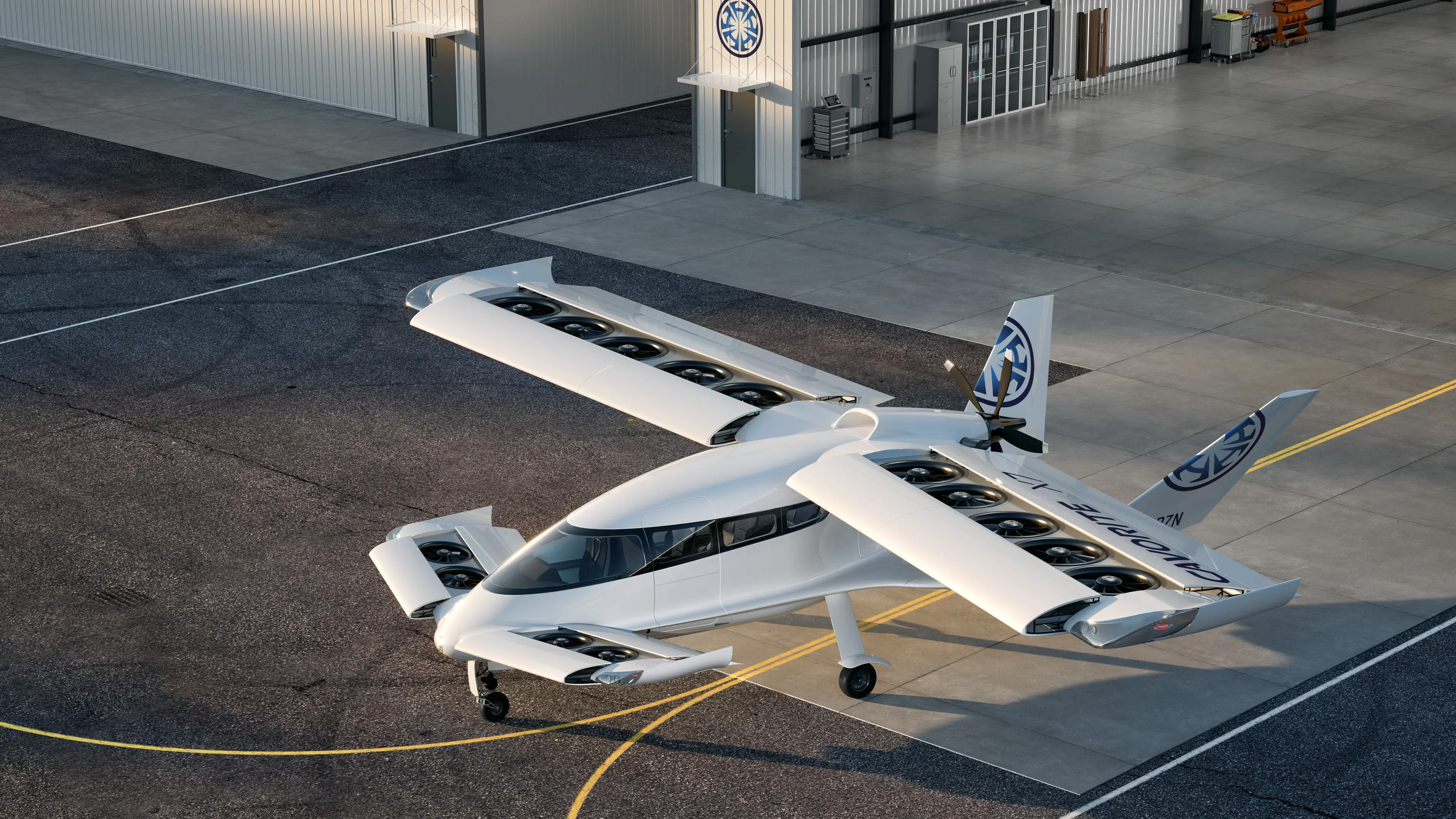 White electric aircraft with multiple rotors mounted along its wings, parked on an airport apron and viewed from above at an angle.