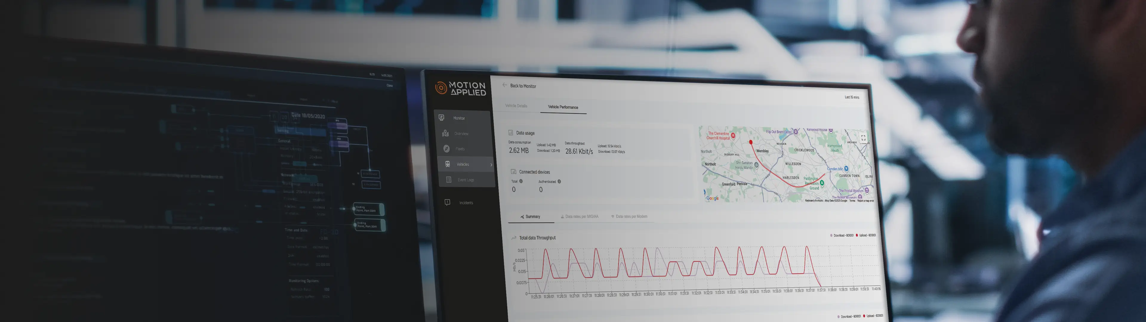 A person sat up to a desk looking at two computer monitors