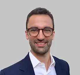 Pablo Garcia Lopez, Director, Connected Intelligence, wearing a dark blue suit jacket over a white collared shirt, posed against a plain light gray background.