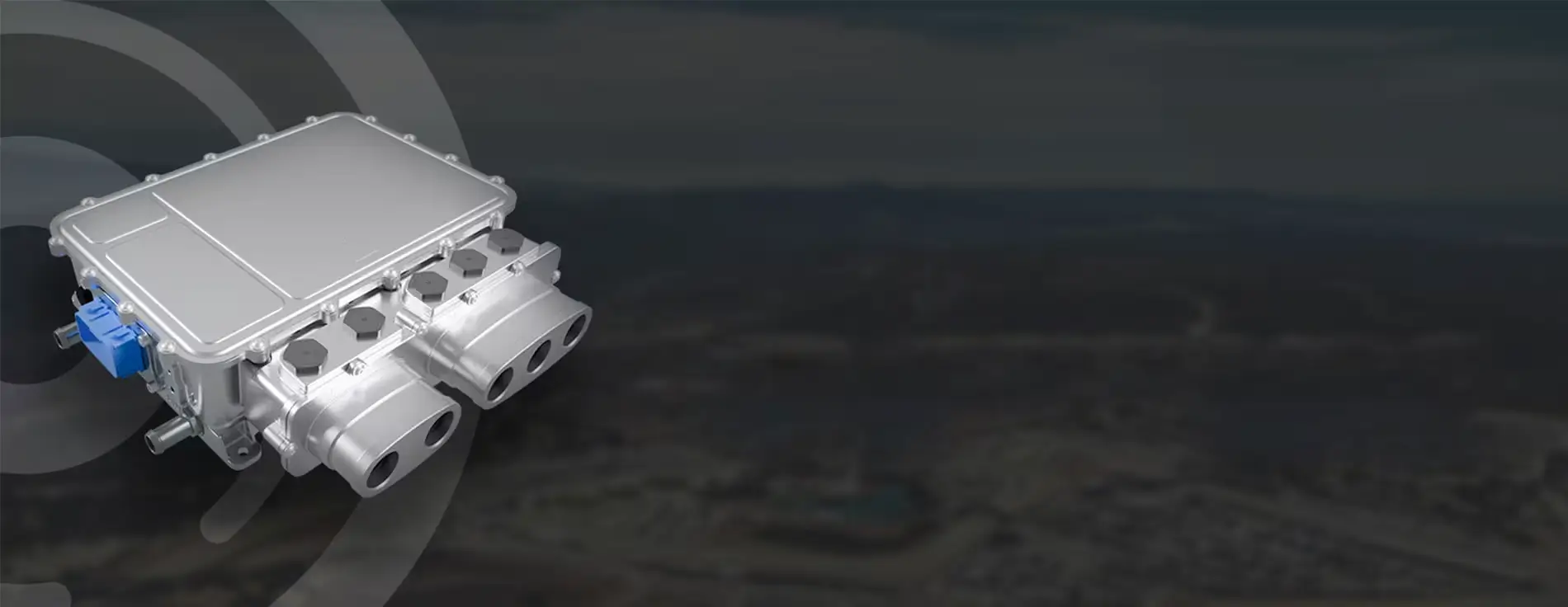 Silver electronic control unit with a rectangular metal housing and multiple cylindrical connectors, shown against a dark background.